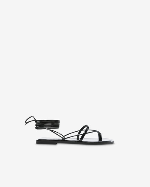 Black patent leather flat sandals with ankle straps
