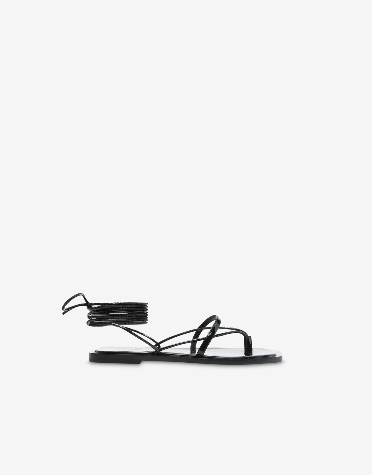 Black patent leather flat sandals with ankle straps
