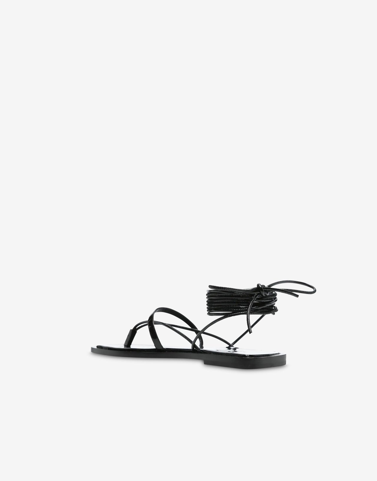 Black patent leather flat sandals with ankle straps